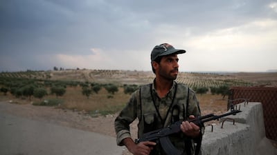 A Syrian security officer mans a checkpoint on the outskirts of Jarablus, northern Syria. AP