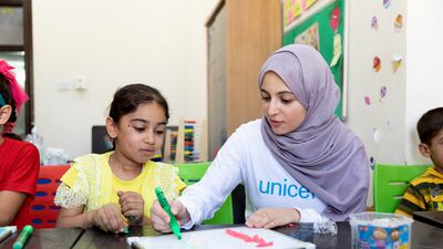 Unicef Goodwill Ambassador Muzoon Almellehan sits with Ahla, 8, during an Arabic learning support class at a Unicef-supported Makani centre in East Amman, Jordan.
