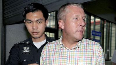 Michael Bryan Smith, right, a British man accused of embezzlement in Dubai, is being held by the Thai police and could face extradition.
