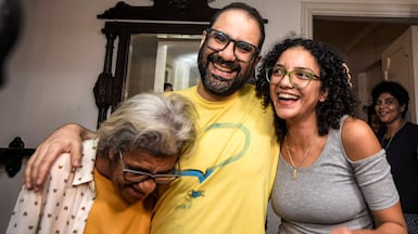British-Egyptian activist Alaa Abdel Fattah embraces his mother and sister after he was released in September. AFP