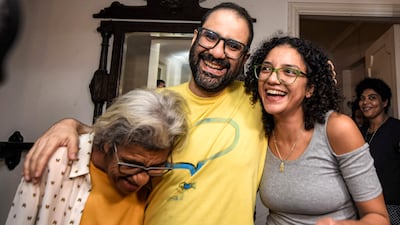 British-Egyptian activist Alaa Abdel Fattah embraces his mother and sister after he was released in September. AFP