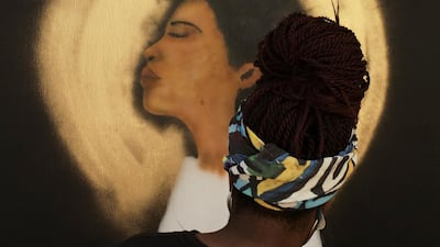 Keiona Clark, curated by Paints Institute, paints a mural on the boarded-up windows of St. John's Church as a work of art activism for racial justice at Black Lives Matter Plaza in Washington, U.S. REUTERS
