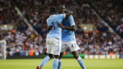 Yaya Toure celebrates with Bacary Sagna after scoring the second goal for Manchester City. Darren Staples / Reuters / August 11, 2015