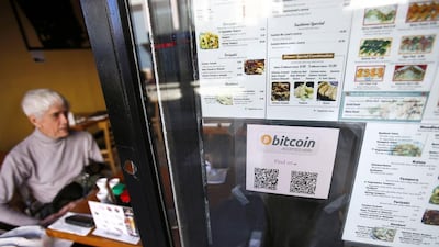 A Bitcoin logo is seen at the window of Nara Sushi, a San Francisco restaurant that accepts Bitcoin as payment. Stephen Lam / Reuters