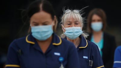 Hospital staff observe a minute's silence outside the Aintree University Hospital in Liverpool. Reuters