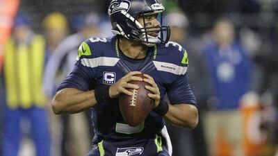 Russell Wilson threw for 310 yards and three touchdowns on Monday night. Elaine Thompson / AP