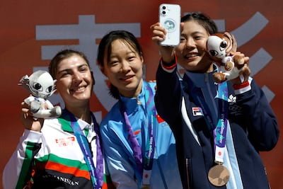 Farbia Hashimi, left, poses on the podium with gold medallist Li Guo of China and Wing Yee Leung of Hong Kong, who won bronze. Reuters