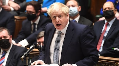 A handout photograph released by the UK Parliament shows Britain's Prime Minister Boris Johnson attending Prime Minister's Questions (PMQs) in the House of Commons in London on January 12, 202. - UK Prime Minister Boris Johnson Wednesday apologised for attending a lockdown-breaching party held in his Downing Street garden, but deflected calls to resign as the opposition leader called him a "man without shame". After days of dismal headlines and collapsing poll ratings, Johnson said he regarded the newly revealed boozy get-together in May 2020 as a work event for Downing Street staff. AFP PHOTO / Jessica Taylor / UK Parliament