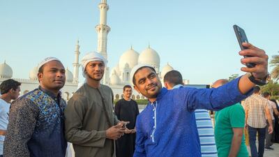 Worshippers celebrate Eid Al Fitr outside Sheikh Zayed Mosque early on Tuesday morning.