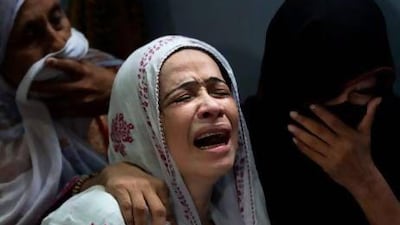 A Pakistani mother mourns the death of her son who was killed in a bomb explosion in a crowded market in Karachi.