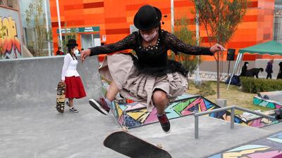 Aide Choque, wearing a mask amid the Covid-19 pandemic, jumps with her skateboard during a youth talent show in La Paz, Bolivia. Young women called "Skates Imillas," using the Aymara word for girl, use traditional Indigenous clothing as a statement of pride of their Indigenous culture when riding their skateboards. AP Photo