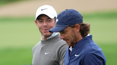 Rory McIlroy of Northern Ireland and Tommy Fleetwood of England smile on course during Day Two of the Hero Dubai Desert Classic at Emirates Golf Club on January 27, 2023. Getty Images