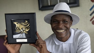 Nigeria’s Wellington Jighere holds his World English-language Scrabble Champion award in Lagos. Pius Utomi Ekpei / AFP