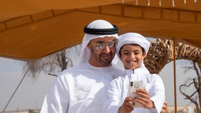 Sheikh Mohamed bin Zayed stands for a photograph with Mohamed Ahmed Jaber Al Harbi. Mohamed Al Hammadi / Ministry of Presidential Affairs
