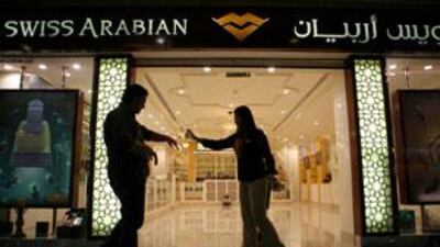 Shoppers sample Arabian perfumes at Swiss Arabian Perfumes in Marina Mall.