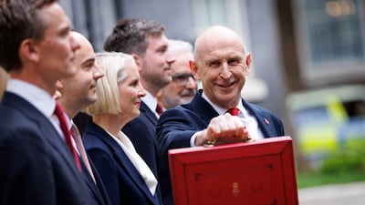 Britain's Chancellor of the Exchequer John Healey holds up his red dispatch box outside No 11 Downing Street in London before delivering his budget. EPA