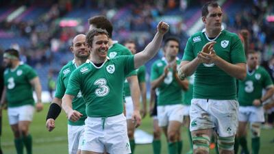 Ireland's Eoin Reddan, left, leads the celebrations after victory over Scotland at Murrayfield. Ian MacNicol / AFP