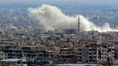 A general view taken from Damascus shows smoke rising from the rebel-held enclave of Eastern Ghouta following fresh air strikes and rocket fire on February 27, 2018. A fledgling "humanitarian pause" announced by Russia in Syria's rebel-held enclave of Eastern Ghouta was rattled by fresh air strikes and rocket fire. Stringer / AFP