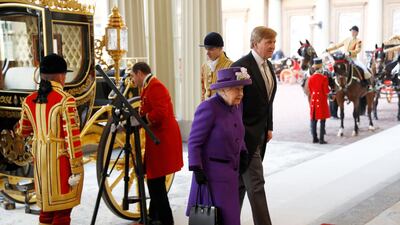 King Willem-Alexander of the Netherlands, right, and Britain's Queen Elizabeth II, left, arrive at Buckingham Palace after a Ceremonial Welcome on Horse Guards Parade in London. Peter Nicholls / AFP