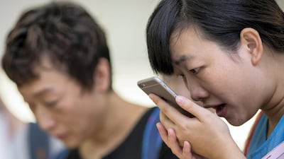 A customer tries the Siri voice recognition function on an iPhone 6 Plus in Hong Kong. Jerome Favre / Bloomberg