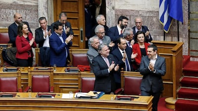 Greek Prime Minister Alexis Tsipras and members of his government applaud after the vote. Reuters.