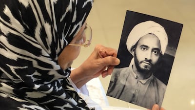 Fatimah Mohamed Soror shows a picture of her father, as she narrates how he entrusted her with the money they get from renting their house for pilgrims.