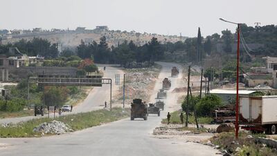 A joint Russian-Turkish patrol passes through the M4 highway on the outskirts of the rebel town of Ariha in Idlib, May 7, 2020. AFP
