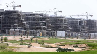 Six out of 18 clusters of apartment towers - each containing 150 homes - have topped out. Pawan Singh / The National