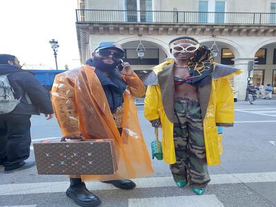 This couple was spotted crossing the road outside Louvre Museum. He is wearing a clean coat and carrying a suitcase, she is in combat trousers and blue high heels. Sarah Maisey / The National
