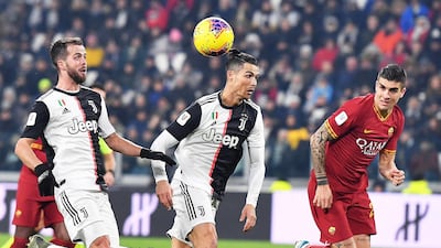 Left to right: Juventus' Miralem Pjanic and Cristiano Ronaldo battle for possession with Gianluca Mancini of Roma. EPA