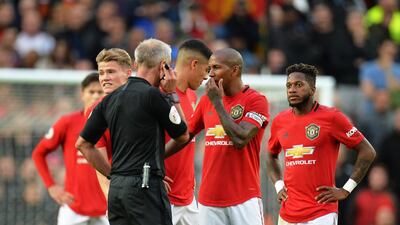 epa07937142 Manchester United's Ashley Young (2-R) argues with referee Martin Atkinson (C-L) during the English Premier League soccer match between Manchester United and Liverpool FC at Old Trafford in Manchester, Britain, 20 October 2019. EPA/PETER POWELL EDITORIAL USE ONLY. No use with unauthorized audio, video, data, fixture lists, club/league logos or 'live' services. Online in-match use limited to 120 images, no video emulation. No use in betting, games or single club/league/player publications.