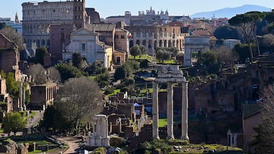 A general view taken from Capitoline Hill shows the ancient Roman Forum and the Colosseum monument on January 13, 2022 in Rome. (Photo by Alberto PIZZOLI / AFP)