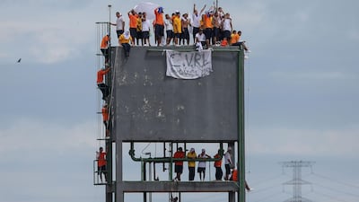 Inmates climb to the top of a tower of the Puraquequara prison to demand better conditions during an uprising in which seven prison guards were taken hostage. AFP