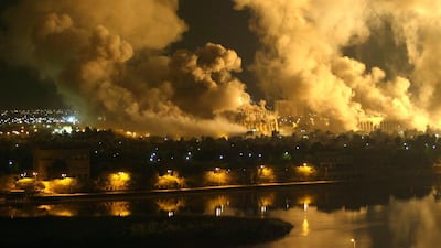 Smoke rises from the presidential palace compound during the 2003 American air strikes in Iraq. Ramzi Haidar / AFP