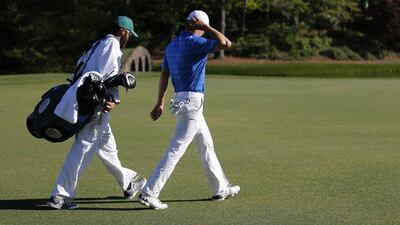 Jordan Spieth of the US (R) and his caddie Michael Greller (L) head to the drop spot after hitting his tee shot into Rae’s Creek on the twelfth hole during the final round of the 2016 Masters Tournament at the Augusta National Golf Club in Augusta, Georgia, USA, 10 April 2016. The Masters Tournament is held 07 April through 10 April 2016. EPA/ERIK S LESSER