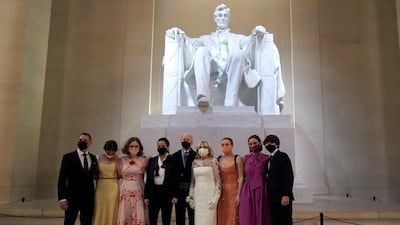 President Joe Biden and first lady Jill Biden, wearing Gabriela Hearst, pose for a photo with family members at the Celebrating America concert at the Lincoln Memorial in Washington on January 20, 2021, after his inauguration. AP Photo