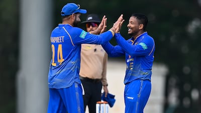 Harpreet Bhatia and Akshdeep Nath, right, celebrate a wicket for UAE. Courtesy ACC