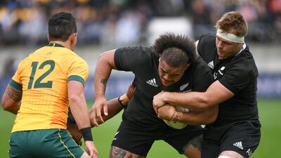 New Zealand's Ofa Tuungafasi, centre, is assisted by teammate Sam Cane, right, as they run at Australia's Matt To'omua during the Bledisloe Cup rugby game between the All Blacks and the Wallabies in Wellington, New Zealand. AP Photo