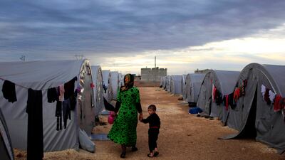 A Kurdish refugee mother and son from the Syrian town of Kobani in a camp in south-eastern Turkey. Getty Images