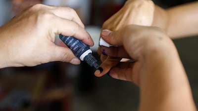 A Filipino receives an indelible ink mark on their finger after voting at an elementary school in Quezon City, east of Manila, Philippines. EPA