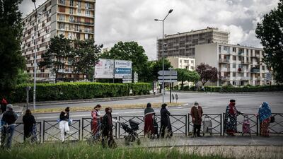 People queue as they wait for food aid distribution conducted by ACLEFEU, a citizens' collective founded during the riots in the French suburbs of November 2005, in Cllichy-sous-Bois, north of Paris, France, 29 April 2020; The Seine-St-Denis department (93) is the poorest in France and has suffered one of the highest contamination and death rates from Covid-19 since the beginning of the containment measures and the nationwide lockdown EPA