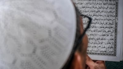 A man reads the Quran Sultan Mahmmud Baddarudin Mosque in Palembang, South Sumatra province. AFP