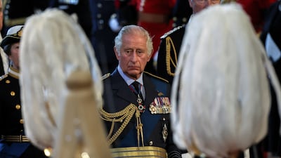 King Charles III behind the coffin of Queen Elizabeth II as it is brought into Westminster Hall, London, where it will lie in state before her funeral on Monday. PA