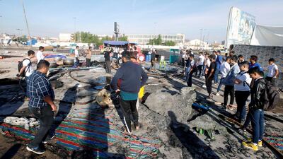 Demonstrators are seen at the place where tents were burned last night during the ongoing anti-government protests in Basra. Reuters
