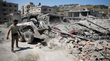 A bulldozer clears the rubble of buildings destroyed in Israeli strikes in the southern Lebanese city of Nabatieh. AFP