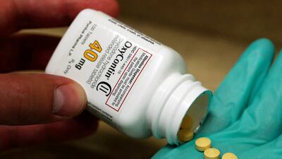 A pharmacist holds prescription painkiller OxyContin made by Purdue Pharma. Reuters