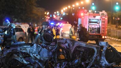 Israeli police investigate the scene of a rocket attack from Lebanon in Kiryat Shmona, northern Israel. AP