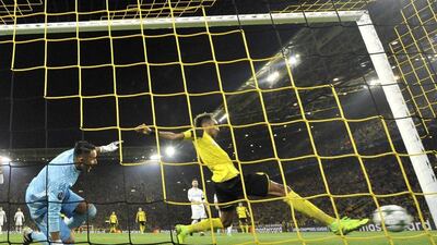 Borussia Dortmund’s Pierre-Emerick Aubameyang, right, scores his side’s opening goal past Real Madrid’s goalkeeper Keylor Navas. Martin Meissner / AP Photo