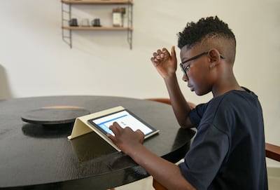 Kasim Smith, a grade three pupil at Raha International School, has been learning money management skills through Squirrel Education. Khushnum Bhandari / The National