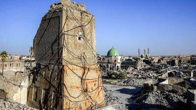 The base of the destroyed Al Hadba leaning minaret in the Old City of Mosul, with the dome of the destroyed Al Nuri Mosque seen behind. AFP